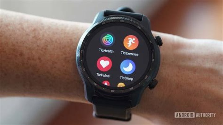 A Mobvoi TicWatch Pro 3 Ultra rests on a wooden surface display additional backlight colors options