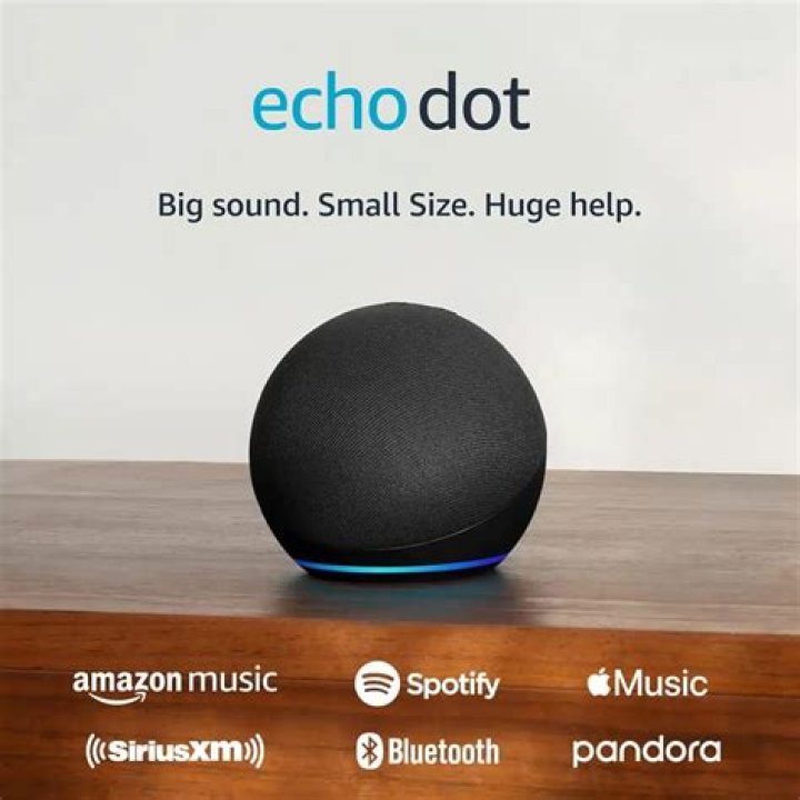 Amazon Echo Dot image on white surface with Android figurine in background.