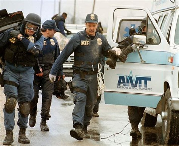 ATF Agents help one of their wounded into an ambulance during the Waco