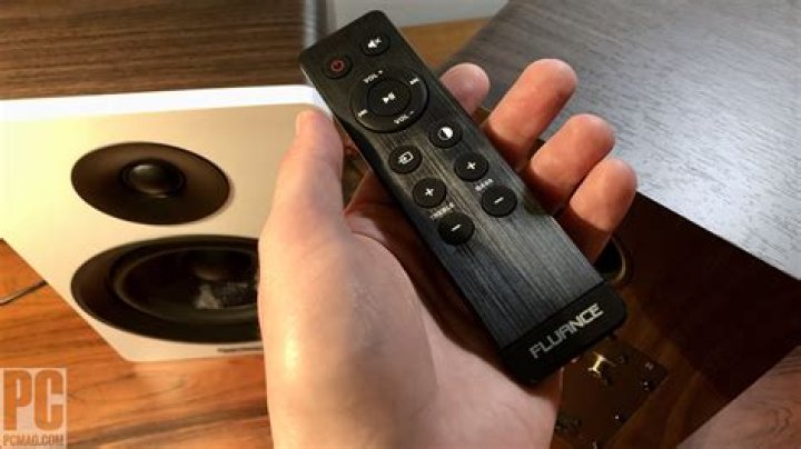 Fluance Ai40 remote, adapter wire, and RCA cable all shown on top of the speaker units.