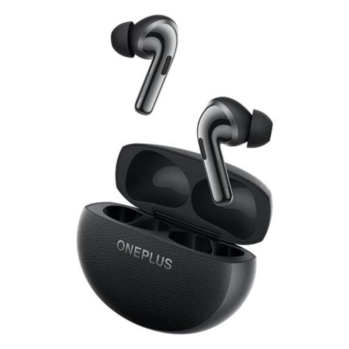 OnePlus Buds Pro in ear in front of phone playing music.