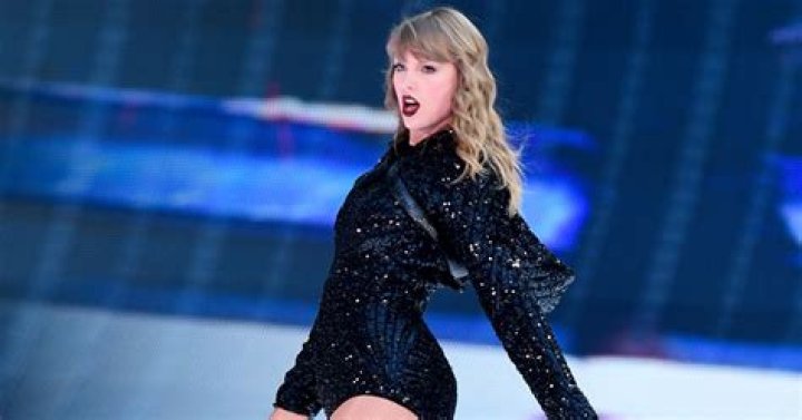 Taylor Swift performing while wearing black onstage